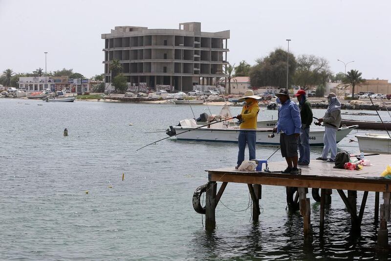 Visitors fish in the old area of Umm Al Quwain. Hotel bosses in the emirate want more action from the authorities to boost tourism. Pawan Singh / The National