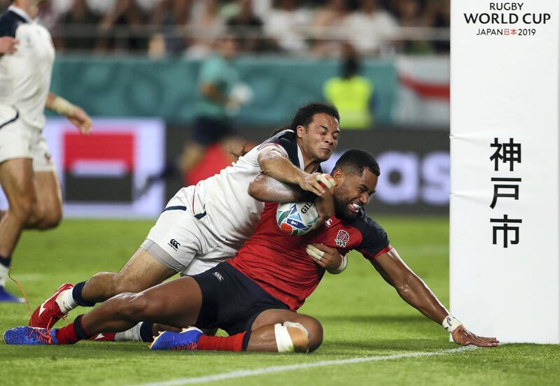 KOBE, JAPAN - SEPTEMBER 26: Joe Cokanasiga of England goes over to score his team's seventh try under a tackle from Mike Teo of USA during the Rugby World Cup 2019 Group C game between England and USA at Kobe Misaki Stadium on September 26, 2019 in Kobe, Hyogo, Japan. (Photo by Francois Nel - World Rugby/World Rugby via Getty Images)