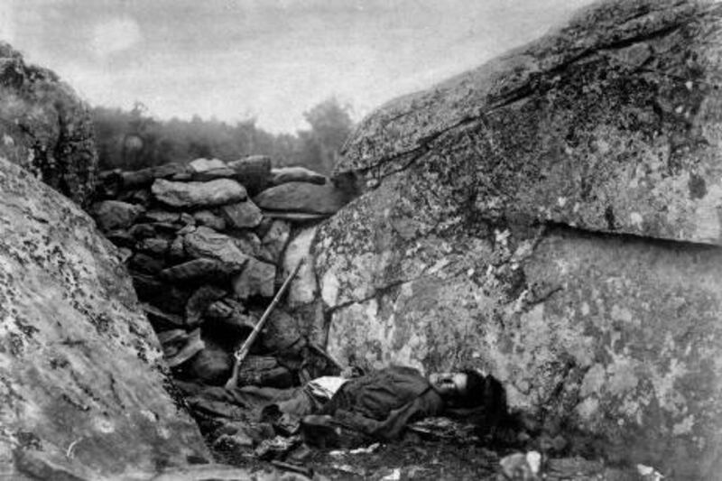 Slain rebel sharpshooter slumped down in his ineffective hideout, w. his rifle still perched against rocks, at end of Battle of Gettysburg during the Civil War.  (Photo by Alexander Gardner/War Department/National Archives/Time Life Pictures/Getty Images)