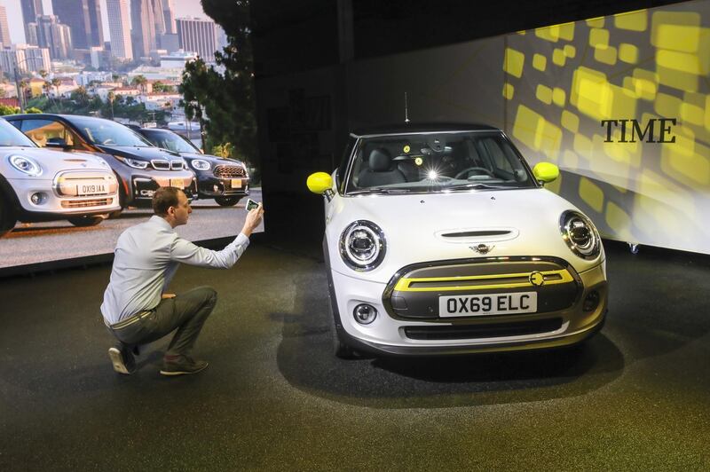 An attendee takes a photograph of the car. Bloomberg