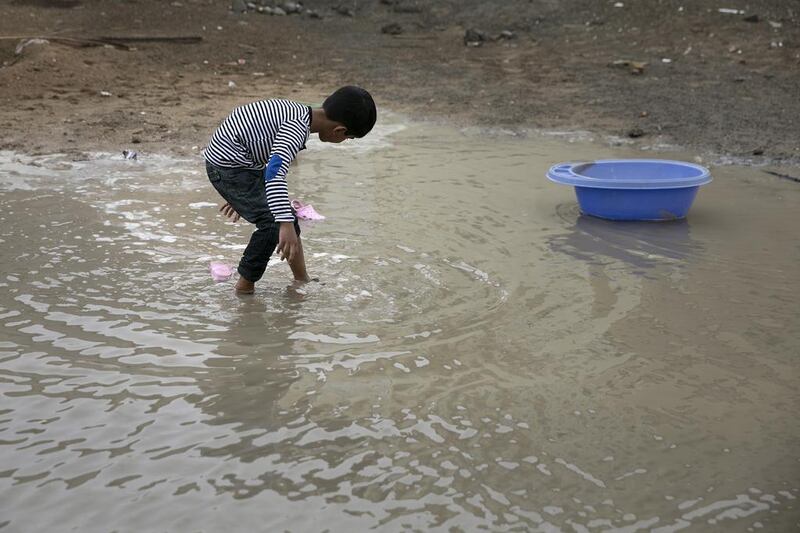 Mohammad Rayan enjoys playing in the rain. Silvia Razgova / The National