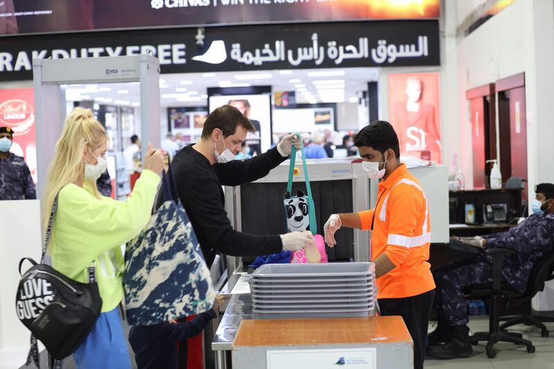 German tourists load their bags into an airport baggage scanner ahead of their flight home to Frankfurt on Saturday. Wam