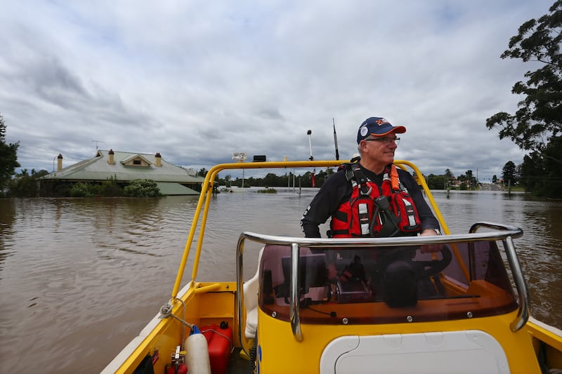 SES Unit Commander Kevin Jones surveys floodwaters in Sydney's Windsor suburb. Getty