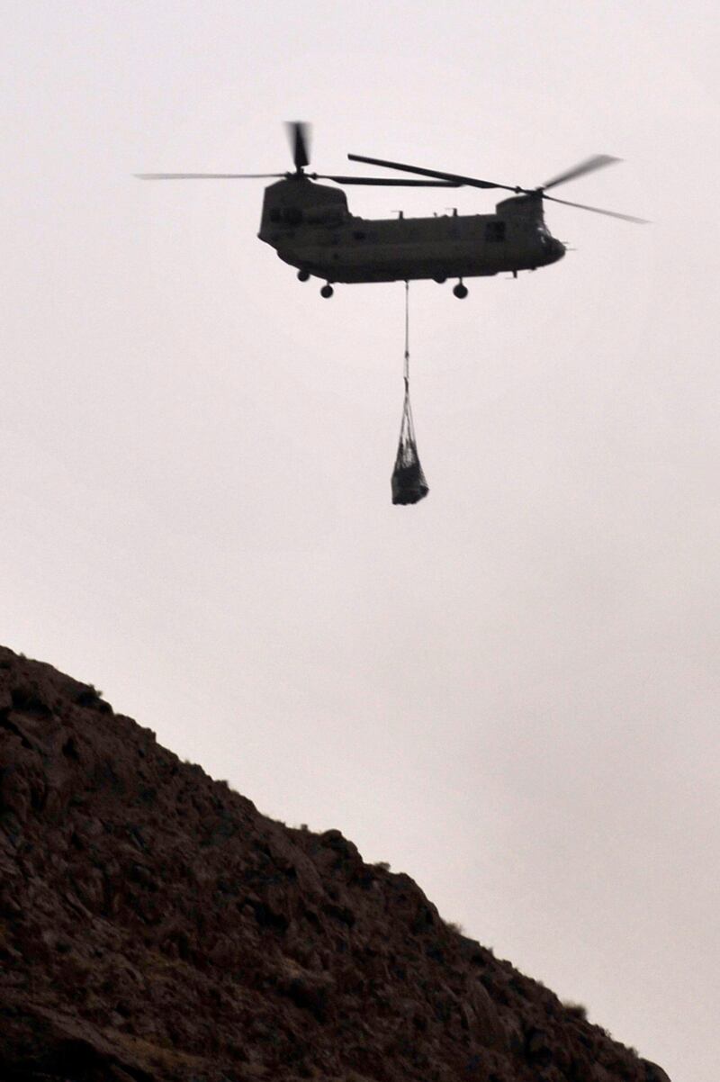 In this photograph taken on July 29, 2011, a US military Chinook helicopter transport cargo over Arghandab district. Thirty-one US special forces and seven Afghans died when the Taliban shot down their helicopter, officials said on August 6, 2011, the deadliest incident yet for foreign troops in a decade-long war. All were killed during an anti-Taliban operation late Friday when a rocket fired by the insurgents struck their Chinook helicopter in Wardak province, southwest of the capital Kabul, as they prepared to leave after a firefight. AFP PHOTO / ROMEO GACAD
 *** Local Caption ***  563950-01-08.jpg