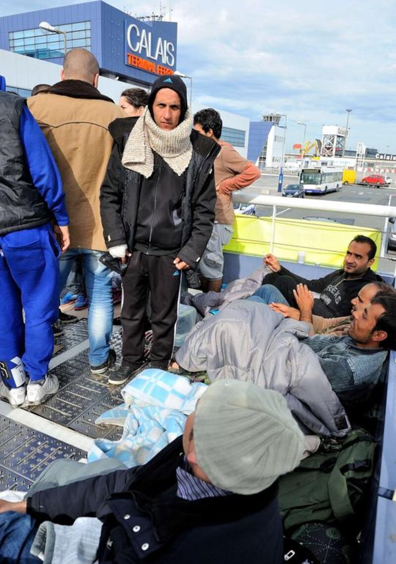 Syrian migrants willing block a gangway leading to the ferry terminal in Calais, France. AFP