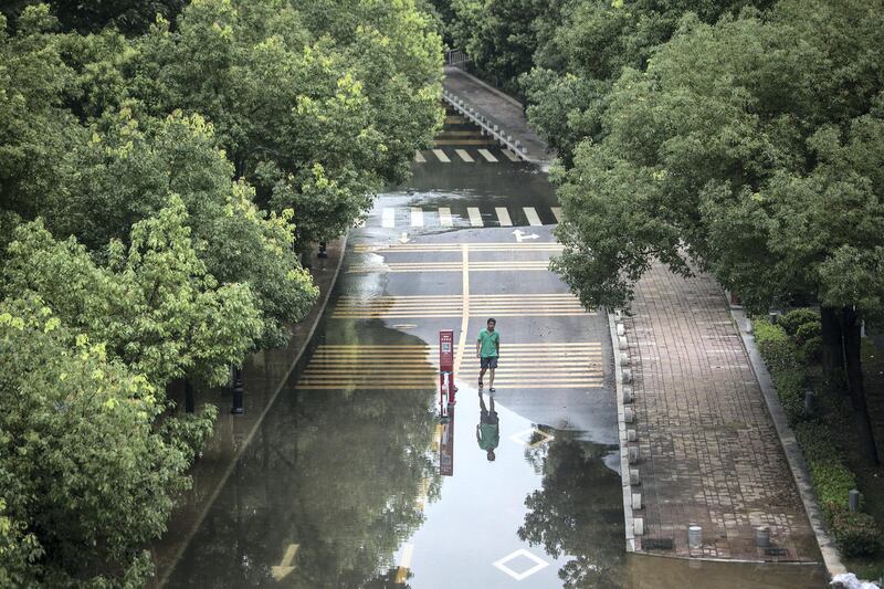 WUHAN, CHINA - JULY 13: (CHINA OUT) A man walks in flooded Jiangtan park caused by heavy rains along the Yangtze river on July 13, 2020 in Wuhan, The water level at Hankou station on the Wuhan section of the Yangtze River has reached 28.77 meters, the fourth highest in history. (Photo by Getty Images)