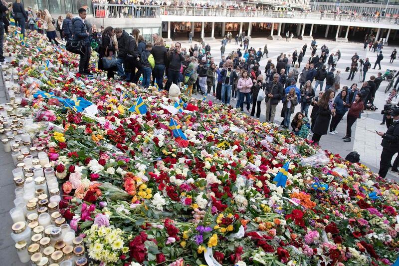 Flowers at Sergels Torg plaza in Stockholm where a lorry driver drove into a department store on April 7, 2017, killing four people. Germany has jailed on terrorist charges five men who were in the same social circle as the perpetrator. AFP
