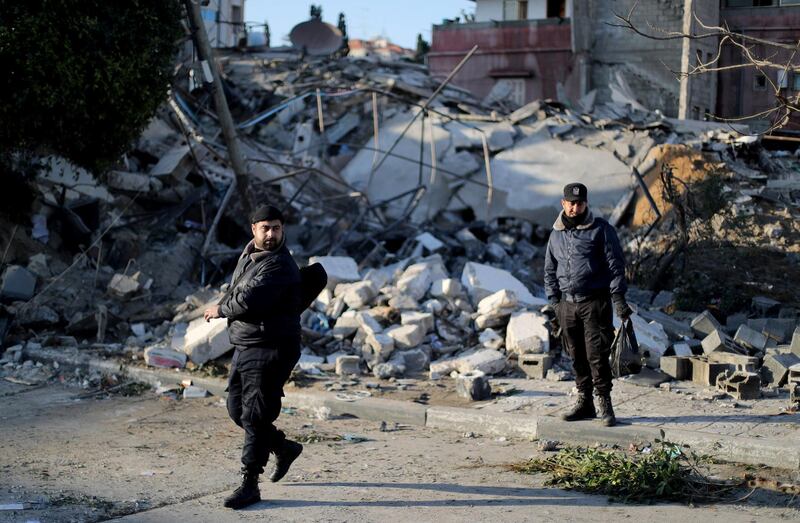 Palestinian policemen stand guard at the site of a Hamas-run insurance office after it was destroyed by an Israeli air strike in Gaza City. Reuters