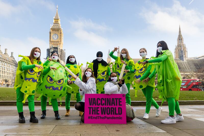 Activists from the anti-poverty organisation the ONE Campaign stage a protest calling for the sharing of coronavirus vaccines with developing countries in Parliament Square in London. EPA