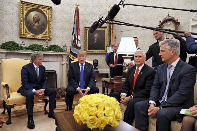 Former U.S. hostage in Yemen, Danny Burch, left, listens as President Donald Trump speaks, Wednesday, March 6, 2019, in the Oval Office of the White House in Washington, next to Vice President Mike Pence, and Special Presidential Envoy for Hostage Affairs Robert O'Brien. At back, to the right of Trump, is national security adviser John Bolton. (AP Photo/Jacquelyn Martin)