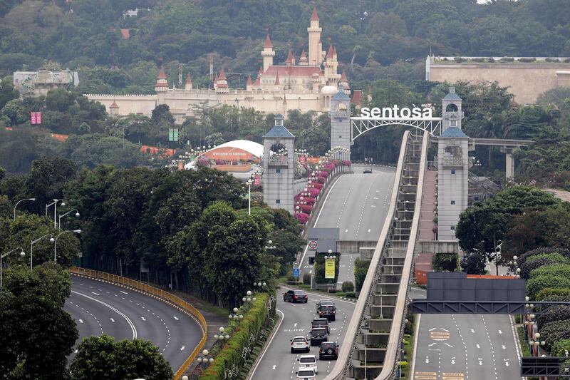 Seen from the Bay Hotel in Singapore, a car, front, carrying North Korean leader Kim Jong Un, enters Sentosa island where the summit between him and US President Donald Trump will take place. Wong Maye-E / AP Photo