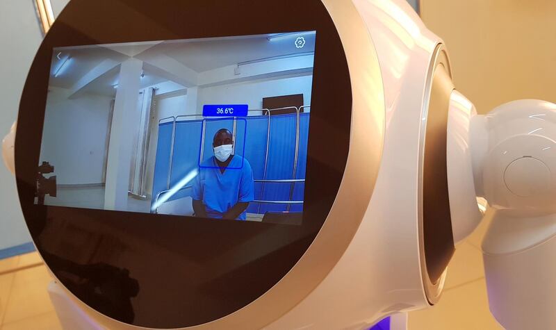 The robot's monitor displays the image of a health worker that it is checking. Reuters