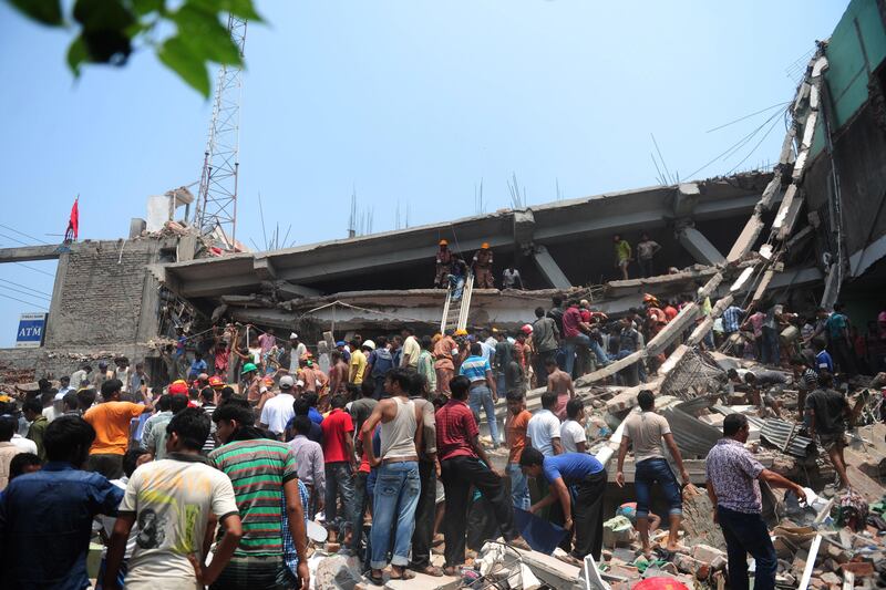 Bangladeshi Army personnel and civilian volunteers work on the scene after an eight-storey building collapsed in Savar, on the outskirts of Dhaka, on April 24, 2013. At least 82 people have died and 700 are injured after a eight-storey building housing several garment factories collapsed on the outskirts of Bangladesh's capital on Wednesday, a doctor said. AFP PHOTO/Munir uz ZAMAN
 *** Local Caption ***  978974-01-08.jpg