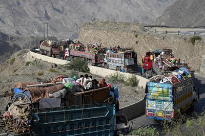 Lorries transporting Afghan refugees with their belongings along a road towards the Torkham border on Friday, AFP