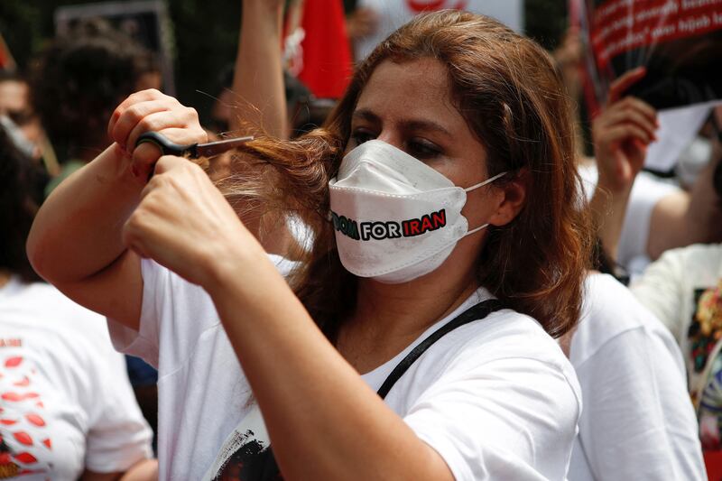 Outside the embassy of Iran in Jakarta, Indonesia, a woman cuts her hair during a protest against the Iranian government the death of Mahsa Amini. Reuters