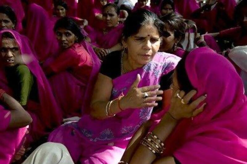 Leader of the Gulabi Gang, Sampat Pal Devi (C) gestures as she chats with members during a protest in New Delhi in 2009. The Gulabi Gang (Pink Gang), a group of women in rural India who strive for social justice, don pink saris and fight for women's rights and better conditions for the poor.