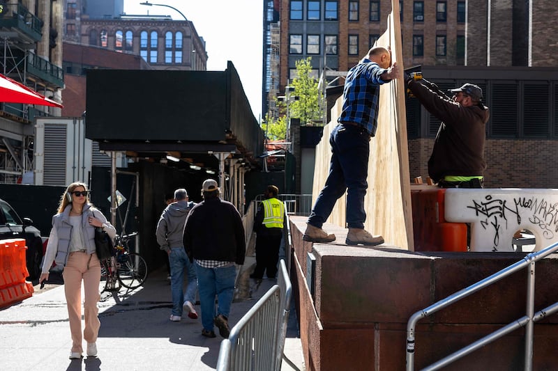 Workers erect a wooden barrier at New York University Stern School of Business after an encampment set up by students was cleared out on Monday night. Getty Images