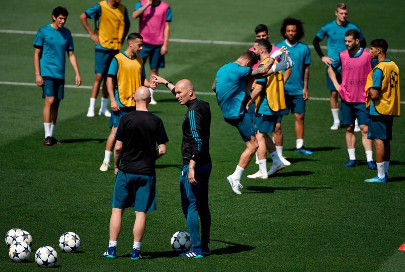 Real Madrid manager Zinedine Zidane talks to a coach during training ahead of the Uefa Champions League final. Gabriel Bouys / AFP