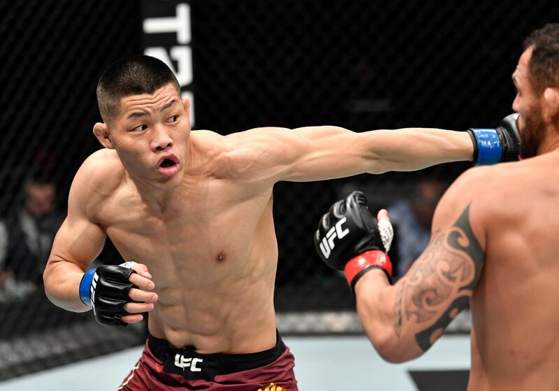 ABU DHABI, UNITED ARAB EMIRATES - JANUARY 17: (L-R) Li Jingliang of China punches Santiago Ponzinibbio of Argentina in a welterweight bout during the UFC Fight Night event at Etihad Arena on UFC Fight Island on January 17, 2021 in Abu Dhabi, United Arab Emirates. (Photo by Jeff Bottari/Zuffa LLC)