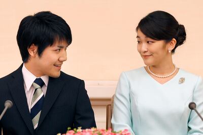 Princess Mako (R), the eldest daughter of Prince Akishino and Princess Kiko, and her fiancee Kei Komuro (L), smile during a press conference to announce their engagement at the Akasaka East Residence in Tokyo on September 3, 2017.
Emperor Akihito's eldest granddaughter Princess Mako and her fianc�� -- a commoner -- announced their engagement on September 3, which will cost the princess her royal status in a move that highlights the male-dominated nature of Japan's monarchy.
 / AFP PHOTO / POOL / Shizuo Kambayashi