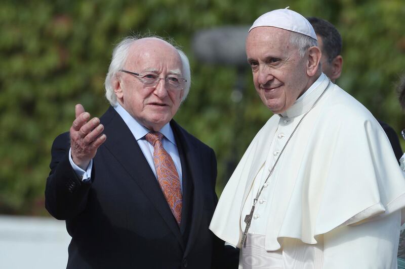 Pope Francis stands by Irish President Michael D Higgins at Aras an Uachtarain in Phoenix Park. PA via AP