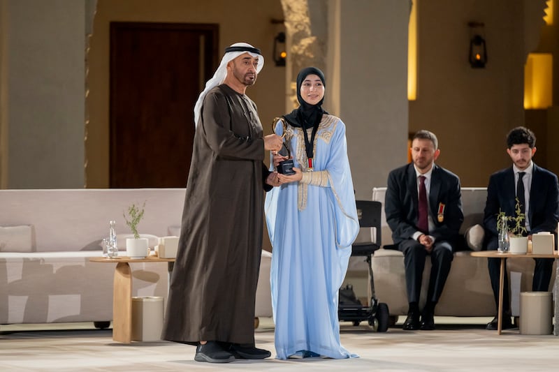 President Sheikh Mohamed presents an Abu Dhabi Award to Salama Saif Al Teneiji in recognition of her work in raising awareness about matters of importance to children and young people, including bullying prevention and online safety. Abdulla Al Neyadi /  UAE Presidential Court 