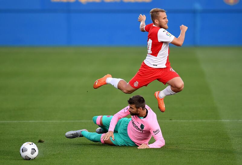 Barcelona defender Gerard Pique tackles Jonas Ramalho of Girona. Getty