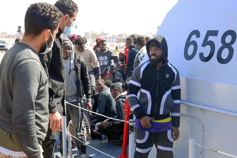 Rescued migrants arrive at a naval base in Tripoli. Some were taken to hospital to be treated for burns and hypothermia. AFP