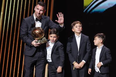 Argentina forward Lionel Messi on stage with his children as he receives his eighth Ballon d'Or in Paris on October 30. AFP