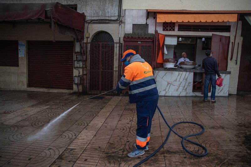 A worker disinfects a street to prevent the spread of the coronavirus during a state of emergency in Rabat, Morocco. AP