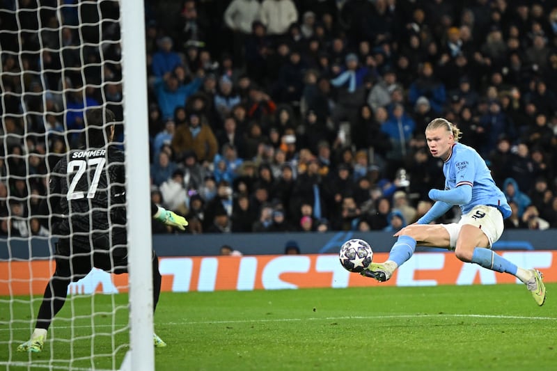 Manchester City's Erling Haaland scores their third goal in the Champions League quarter-final first leg against Bayern Munich at the Etihad Stadium on April 11, 2023. AFP