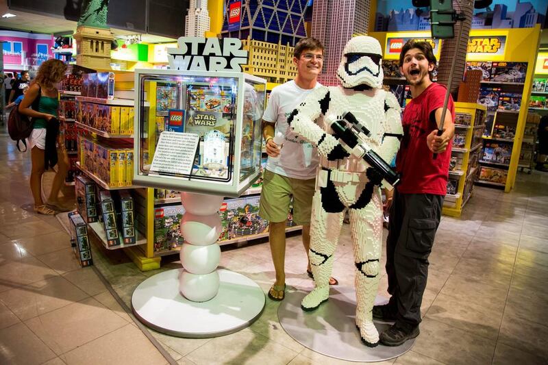 Attendees take a selfie photograph with a Storm Trooper made from Lego ahead of the “Force Friday” event at a Toys R Us Inc. Store in New York. Michael Nagle / Bloomberg
