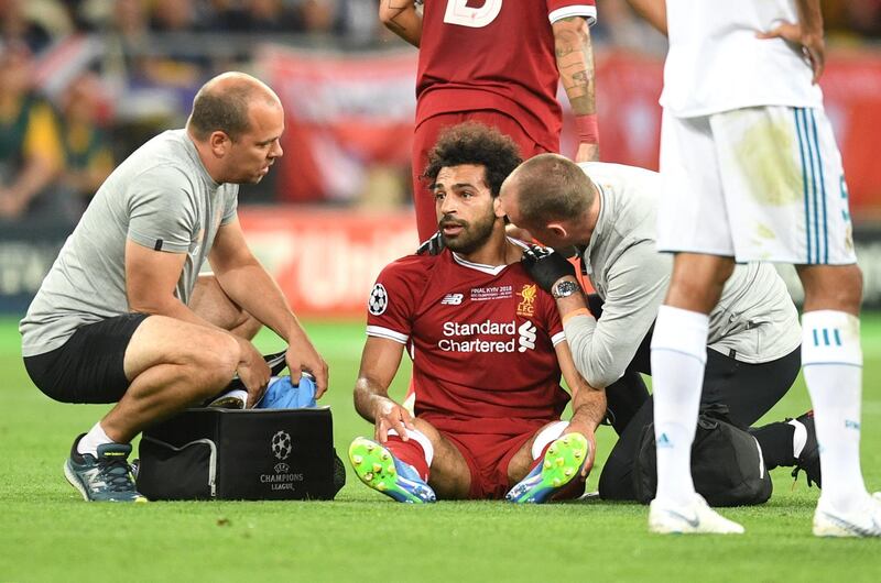 KIEV, UKRAINE - MAY 26:  Mohamed Salah of Liverpool receives treatment from the medical team during the UEFA Champions League Final between Real Madrid and Liverpool at NSC Olimpiyskiy Stadium on May 26, 2018 in Kiev, Ukraine.  (Photo by Michael Regan/Getty Images)