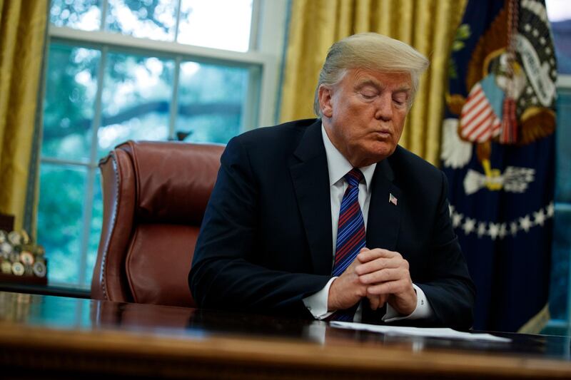 In this Aug. 27, 2018, photo, President Donald Trump talks on the phone with Mexican President Enrique Pena Nieto, in the Oval Office of the White House in Washington. (AP Photo/Evan Vucci)