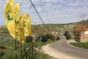 Hezbollah flags flutter along an empty street in south Lebanon amid the coronavirus outbreak. Reuters  
