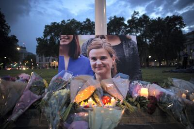 LONDON, UNITED KINGDOM - JUNE 16:  Flowers surround a picture of Jo Cox during a vigil in Parliament Square on June 16, 2016 in London, United Kingdom.  Jo Cox, 41, Labour MP for Batley and Spen, was shot and stabbed by an attacker at her constituicency today in Birstall, England. A man also suffered slight injuries during the attack. Jo Cox was reportedly shot and stabbed while holding her weekly surgery at Birstall Library, Birstall near Leeds and later died. A 52-year old man has been arrested in connection with the crime.  (Photo by Dan Kitwood/Getty Images)