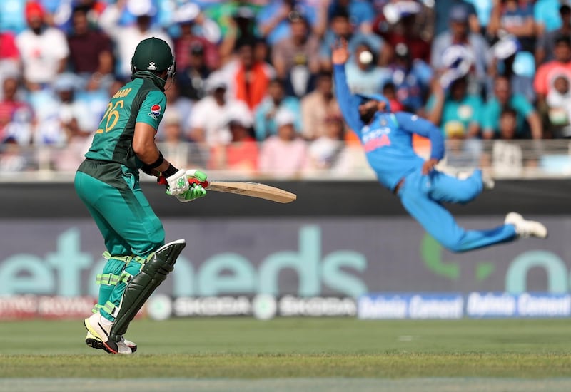 Dubai, United Arab Emirates - September 23, 2018: Pakistan's Imam-ul-Haq puts one past India's flying Ravindra Jadeja during the game between India and Pakistan in the Asia cup. Sunday, September 23rd, 2018 at Sports City, Dubai. Chris Whiteoak / The National
