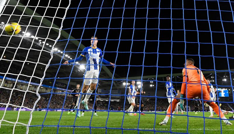 Brighton goalkeeper Robert Sanchez watches as a shot from Arsenal's Martin Odegaard hits the back of the net. AFP