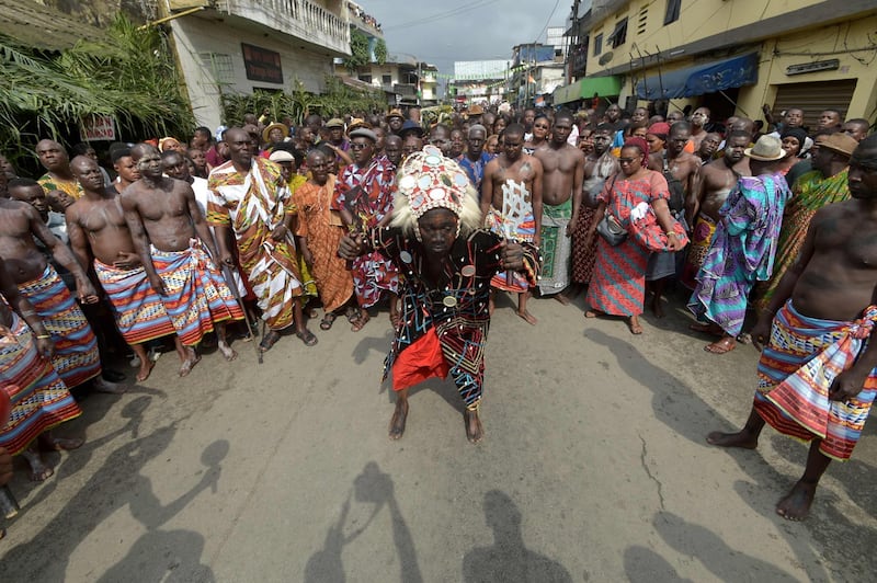 A warrior of the "Blessoue Djehou generation" from an Ebrie village performs a dance in support to those of Adjame village in Abidjan during the "Fatchue" ceremony.   AFP