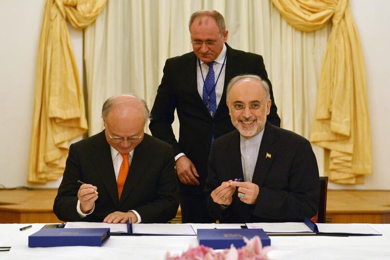 IAEA director general Yukiya Amano, left, and vice president of the Islamic Republic of Iran Ali Akhbar Salehi sign a roadmap for the clarification of past and present issues regarding Iran’s nuclear programme in Vienna. EPA