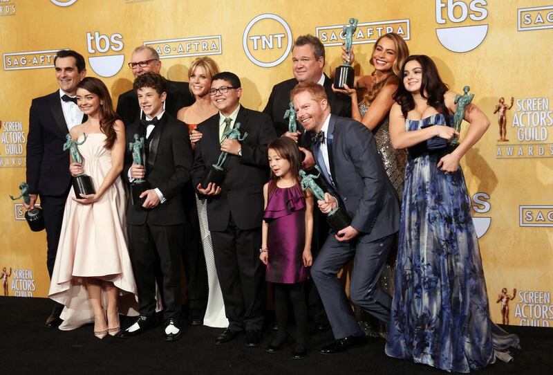 The cast of Modern Family poses with their awards for outstanding performance by an ensemble in a comedy series for Modern Family. AP