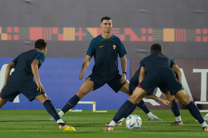 Portugal's Cristiano Ronaldo, centre, warms up with his teammates during training. AP
