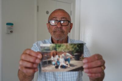 Luke Symons' grandfather Robert Cummings holds a family photograph. Victoria Pertusa / The National