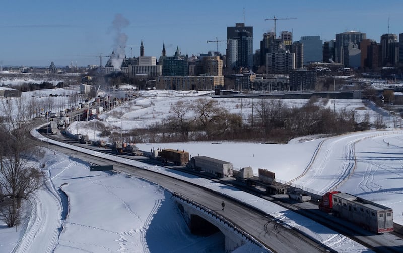 Lorries in the 'Freedom Convoy' are parked on the Sir John A Macdonald motorway leading into Ottawa's city centre. AP