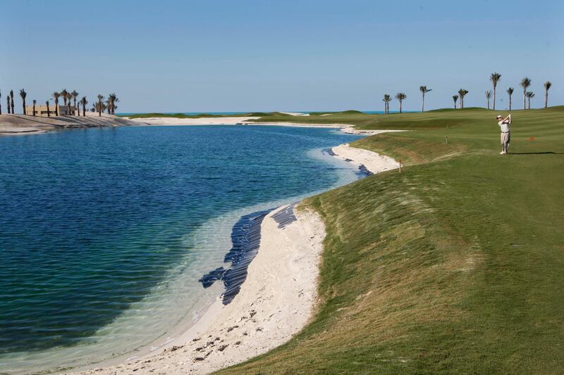 ABU DHABI. 9th February  2010.  SAADIYAT BEACH GOLF CLUB . A golfer plays a shot beside one of the man made lakes at the Saadiyat Beach Golf Club yesterday(tues)  Stephen Lock   /  The National  . 