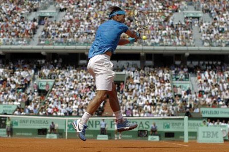 Rafael Nadal, of Spain, hits a return to Switzerland's Roger Federer during their men's French Open final at Roland Garros yesterday.