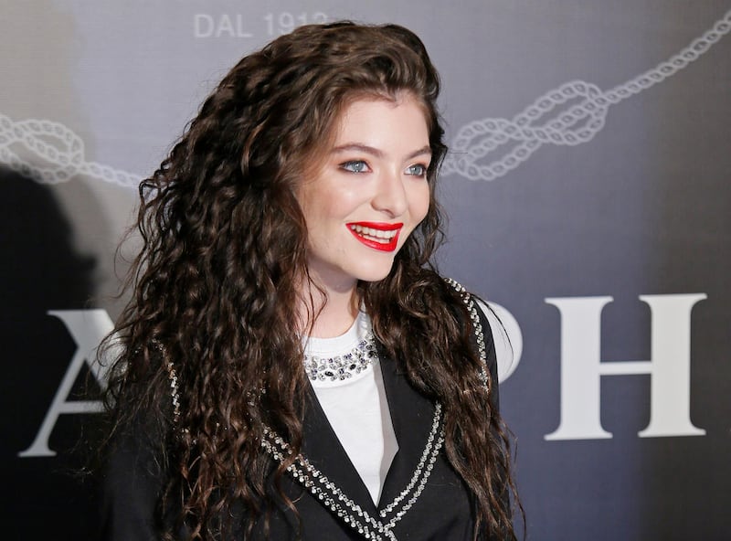 FILE - In this Nov. 18, 2014, file photo, singer Lorde poses for photographers during an promotional event in Hong Kong. An Israeli court has ordered two New Zealand women to pay over $12,000 in damages for allegedly helping persuade the pop singer Lorde to cancel a performance in Israel. The suit was filed under a law that allows civil lawsuits against anyone who calls for a boycott against Israel. (AP Photo/Vincent Yu, File)