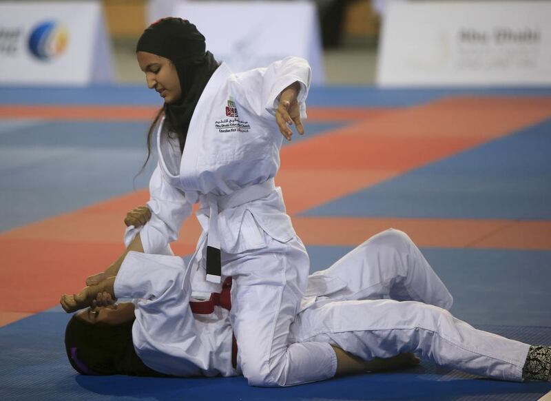 ABU DHABI - UNITED ARAB EMIRATES - 06NOV2015 - Abeer Saraj Ahmed (red belt) fights with Abla Ali al Mansouri in the Martyrs Championships for juniors Jiu Jitsu yesterday at IPIC Arena at Zayed Sports City in Abu Dhabi. Ravindranath K / The National (to go with Amit story for Sports)