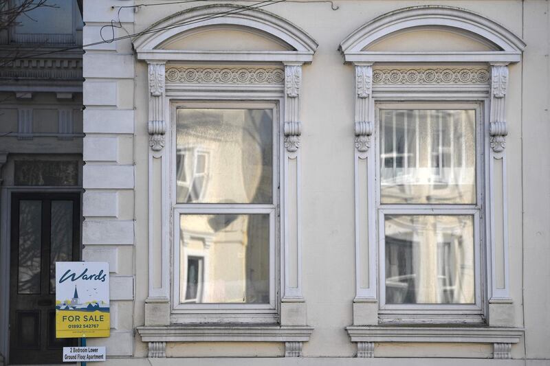 A For Sale signs is attached to a building in Tunbridge Wells, southeast England on March 1, 2021. / AFP / Ben STANSALL
