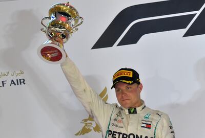 Mercedes' Finnish driver Valtteri Bottas holds his second place trophy on the podium during the Bahrain Formula One Grand Prix at the Sakhir circuit in Manama on April 8, 2018.  / AFP PHOTO / GIUSEPPE CACACE